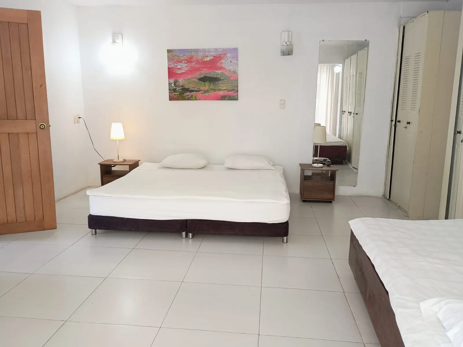 Room 8 in the apartment: king bed with two bedside tables