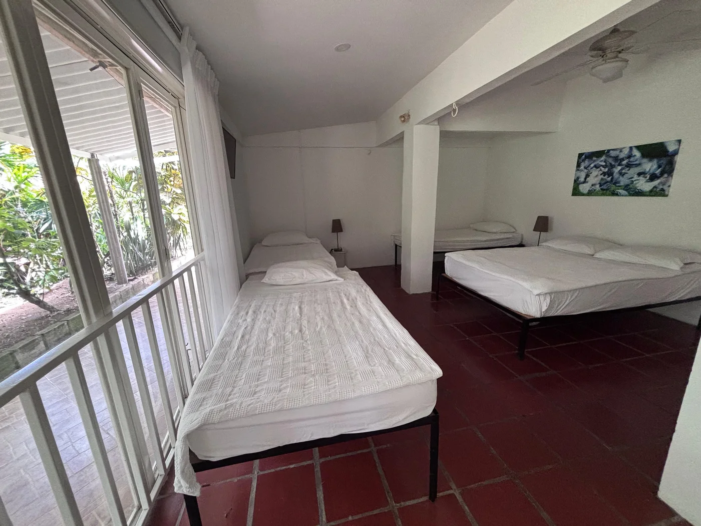 Room with a double bed and artwork